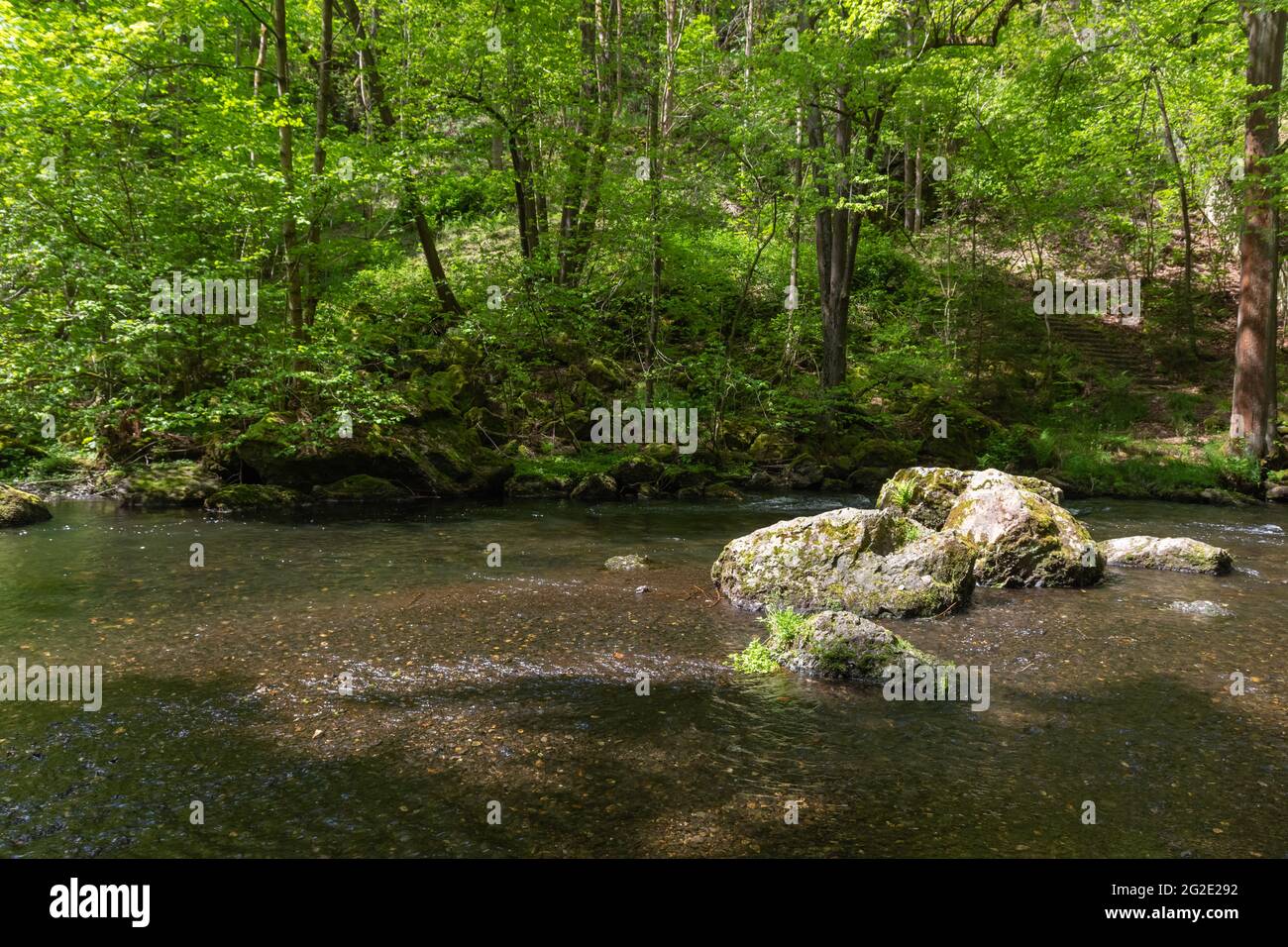 River Surrounded By Rocks Beautiful view of a river surrounded by rocks and trees Stock Photo - Alamy