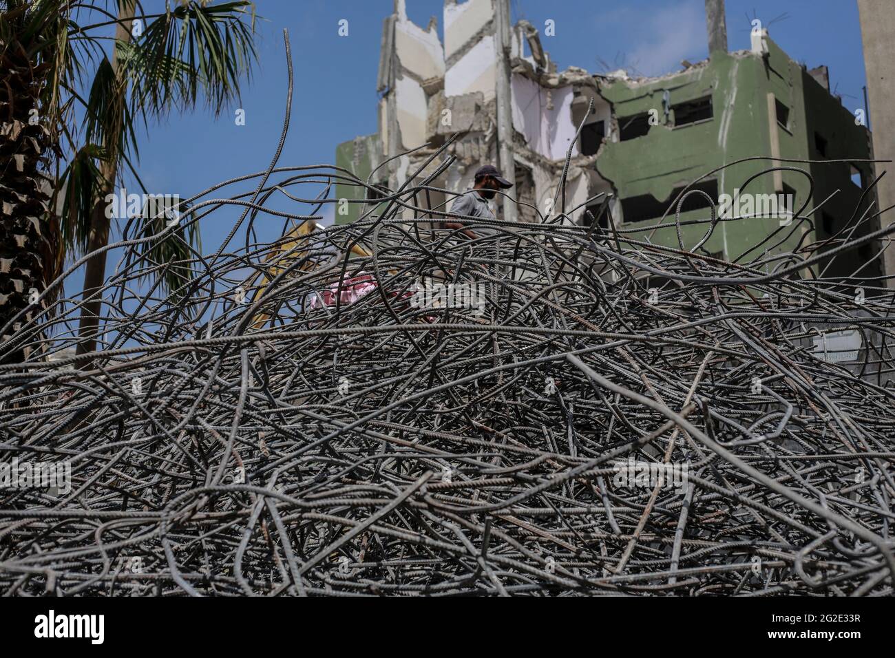 Palestinian workman seen on top of the rebar from the demolished