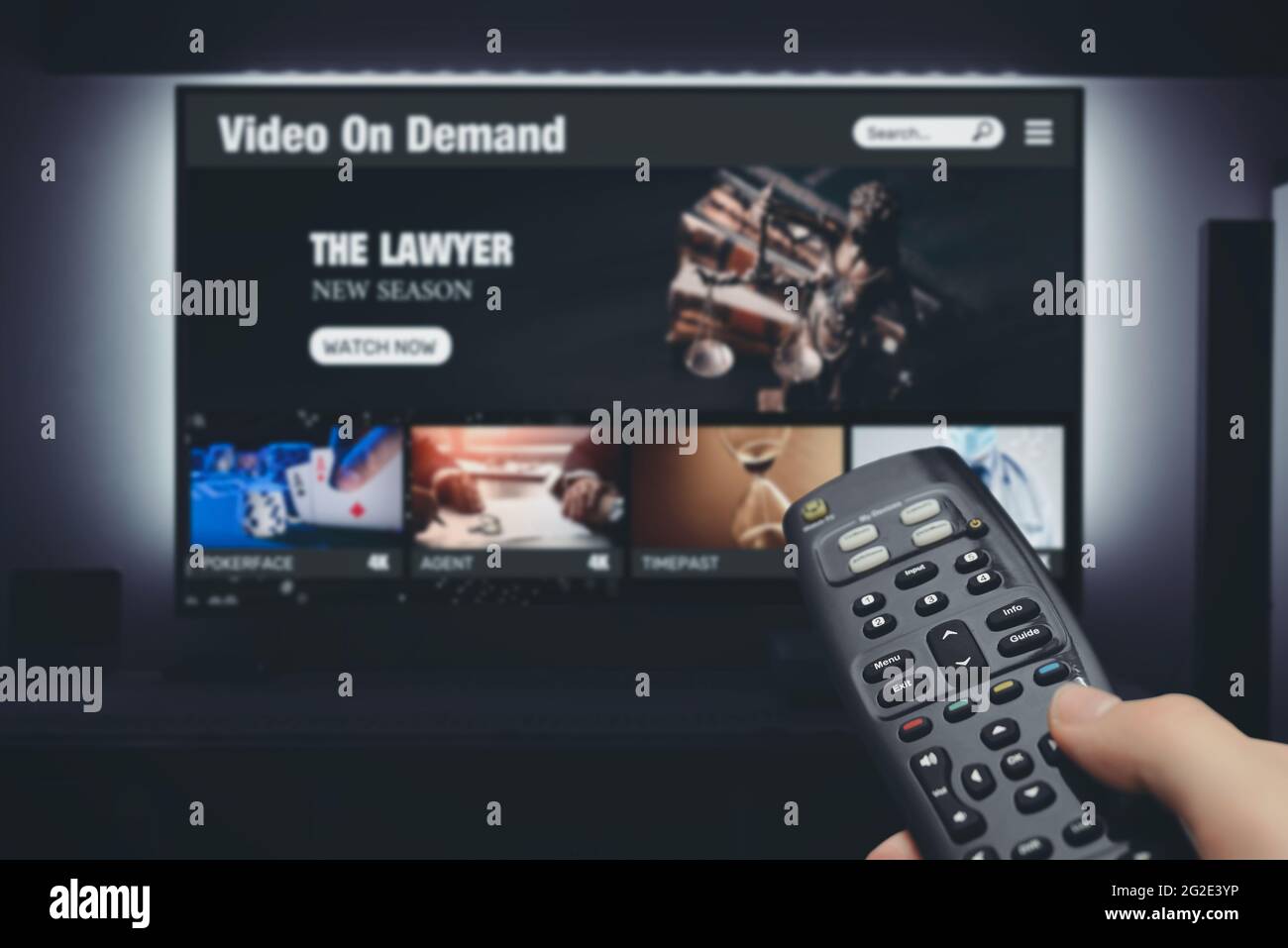 Video on demand, TV streaming, multimedia. Hand holding remote control Stock Photo