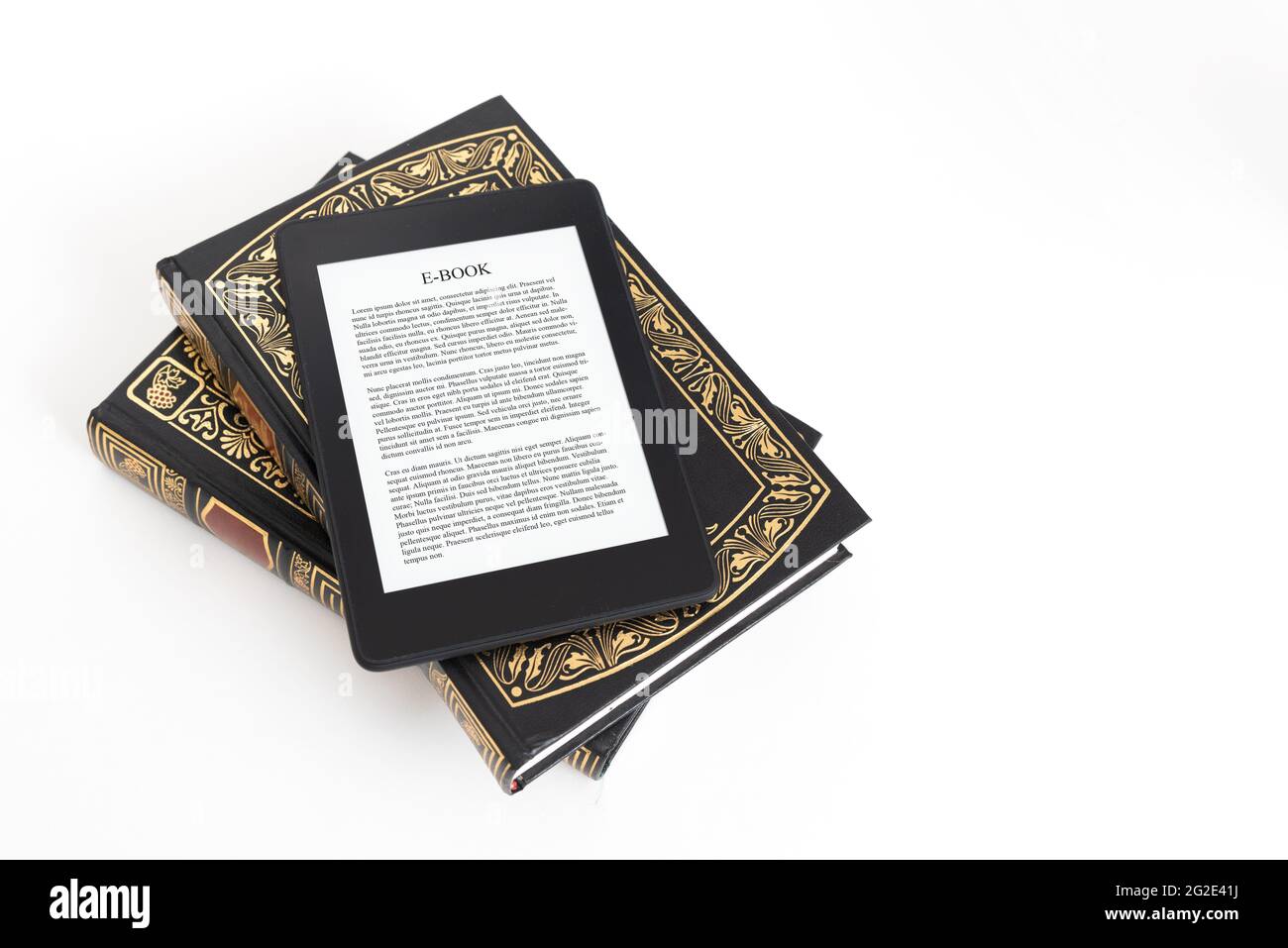 E-book reader with traditional books composition. Book reading with e-book device concept Stock Photo