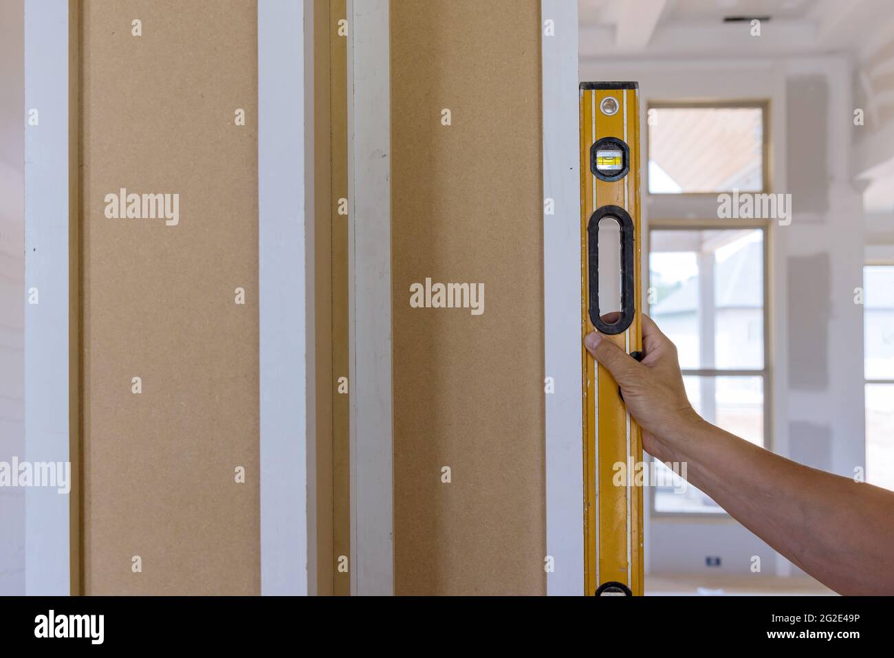 Worker using leveling instrument check appropriate wood columns using level Stock Photo