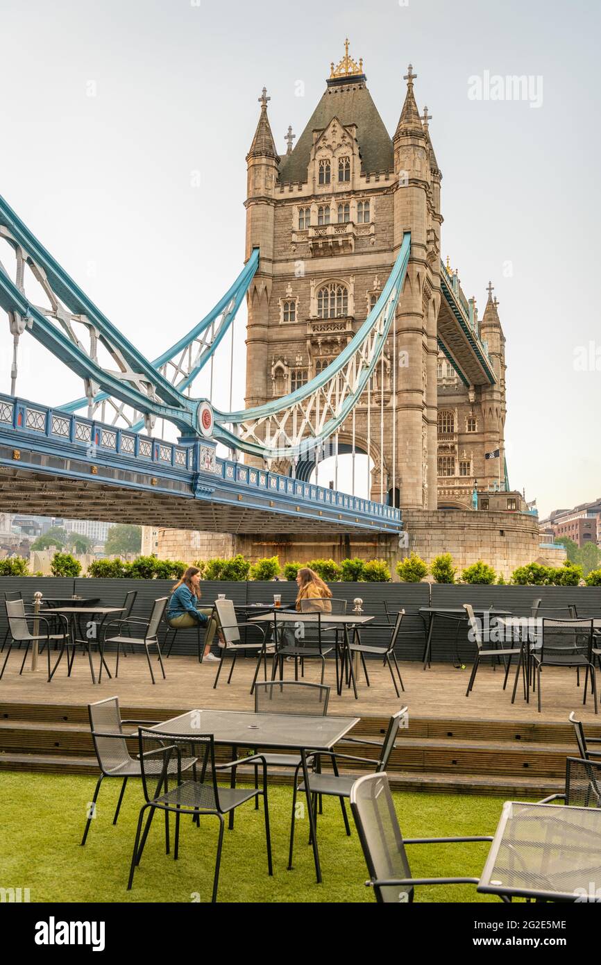 Drinkers at bar overlooking Tower Bridge over the River Thames at Dusk ...