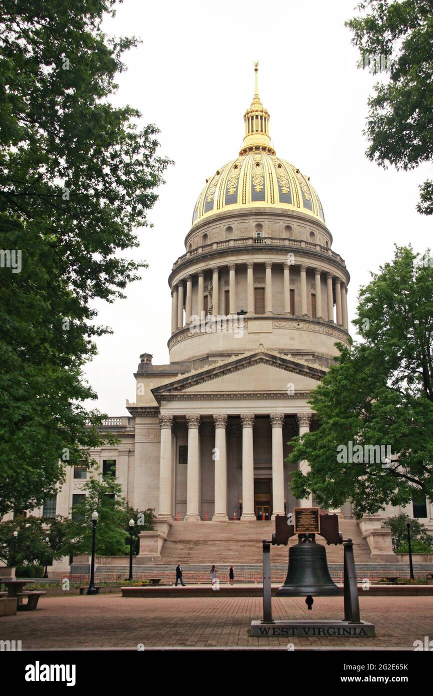Charleston, WV, USA. The West Virginia State Capitol, with a reproduction of the Liberty Bell, symbol on independence, displayed on the grounds. Stock Photo