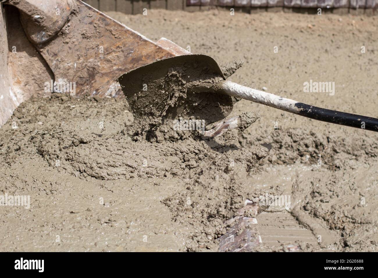 Shovel with cement. The cement is applied with a shovel into the