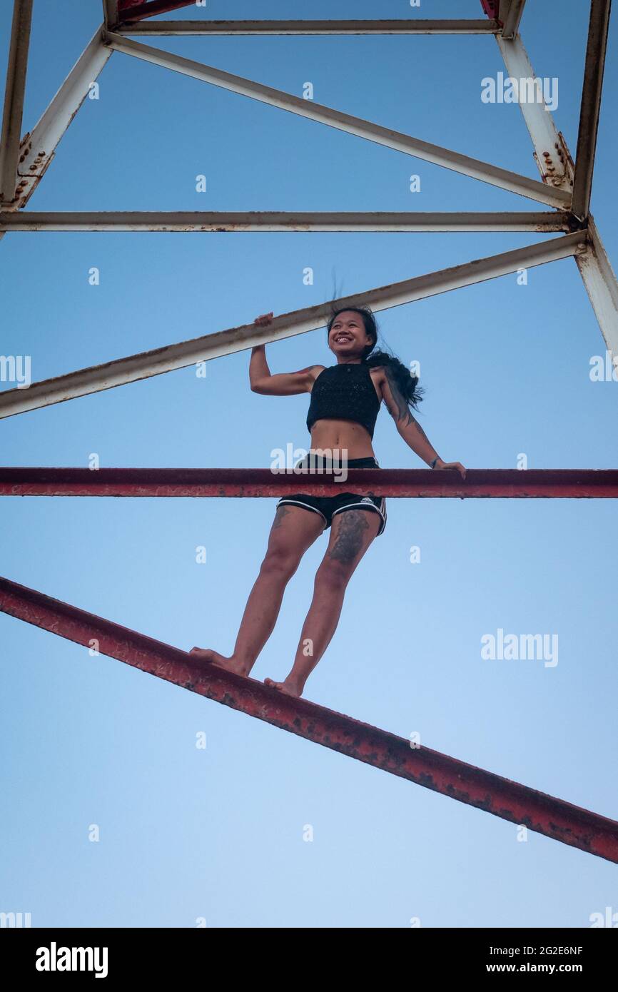 Uribia, La Guajira, Colombia - May 27 2021: Young Asian Woman is Climbing the Metal Tower at the Top of the Lighthouse at Punta Gallinas (Cape Gallina Stock Photo