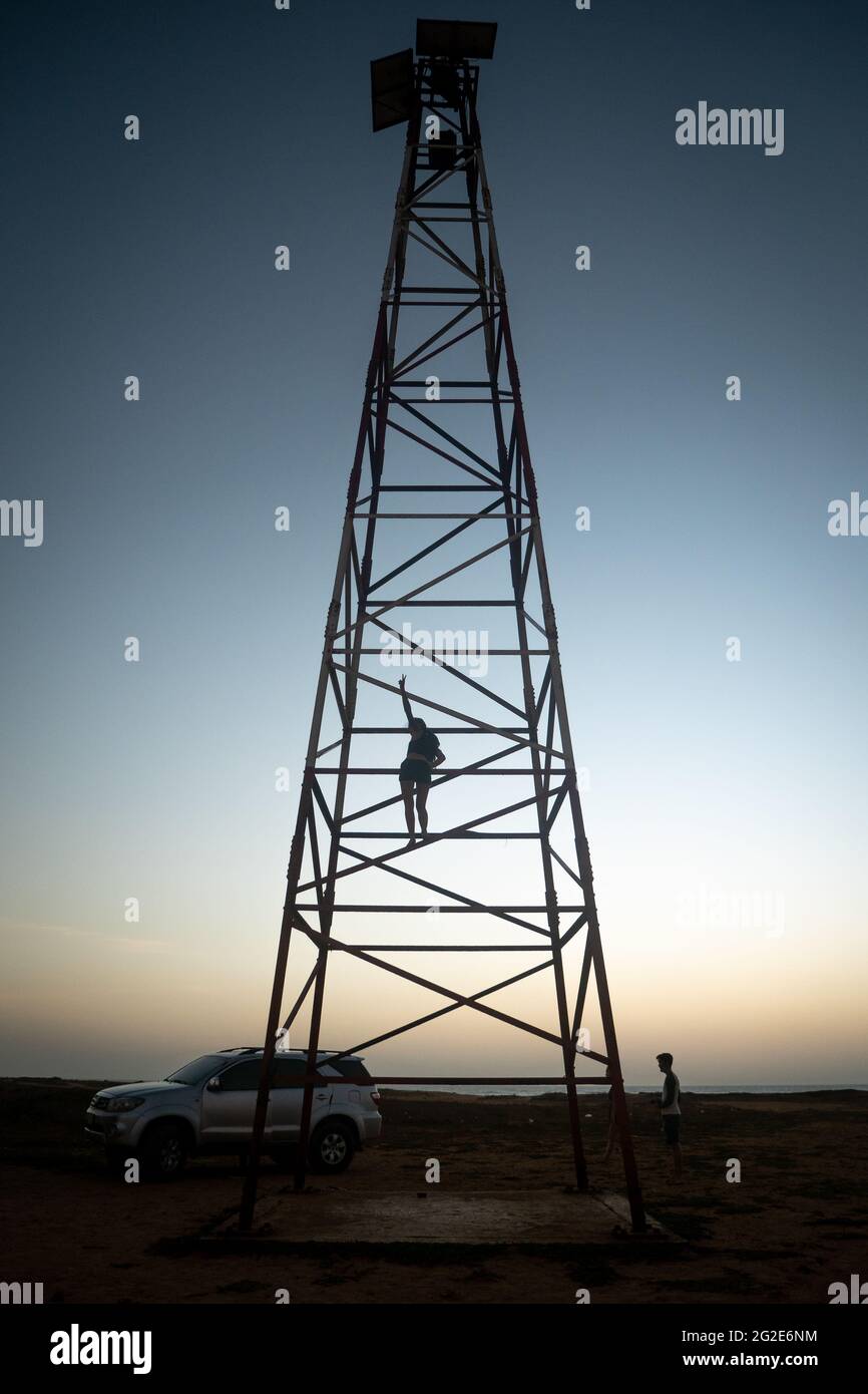 Uribia, La Guajira, Colombia - May 27 2021: Young Woman is Climbing the Metal Tower at the Top of the Lighthouse at Punta Gallinas (Cape Gallinas, 'Ca Stock Photo