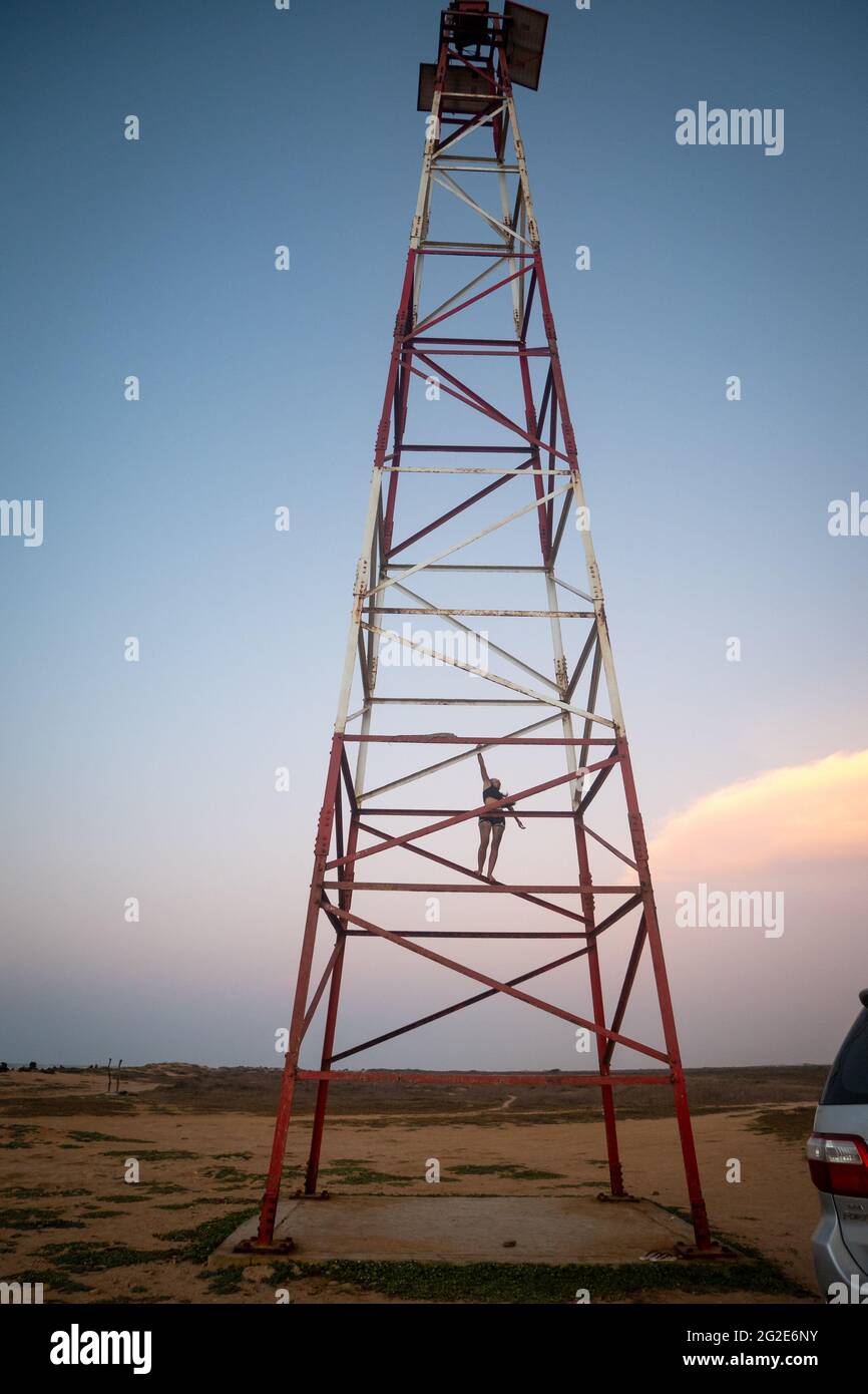 Uribia, La Guajira, Colombia - May 27 2021: Young Woman is Climbing the Metal Tower at the Top of the Lighthouse at Punta Gallinas (Cape Gallinas, 'Ca Stock Photo