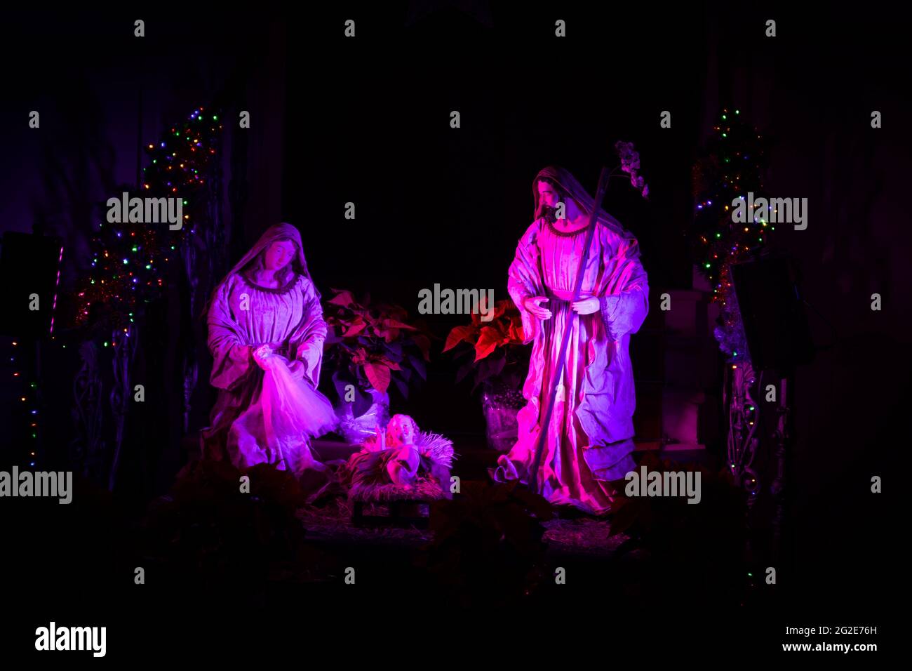 Scene that recreates the birth of Jesus in Bethlehem with figures and artificial lights that evoke Christmas Stock Photo