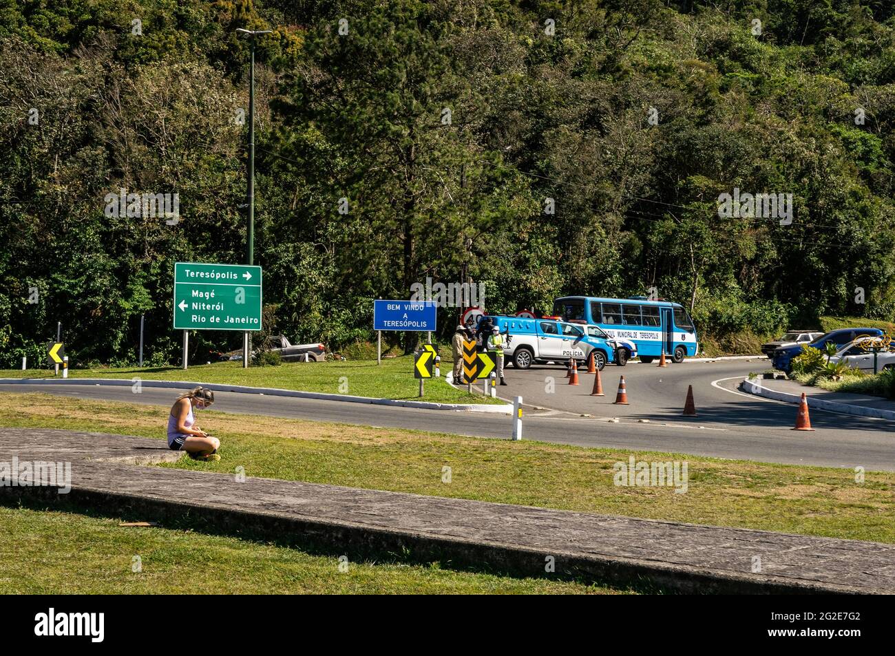 Partial view of the Rio-Teresopolis highway (BR-116) cloverleaf interchange with some police cars and officers at the access road to Teresopolis. Stock Photo