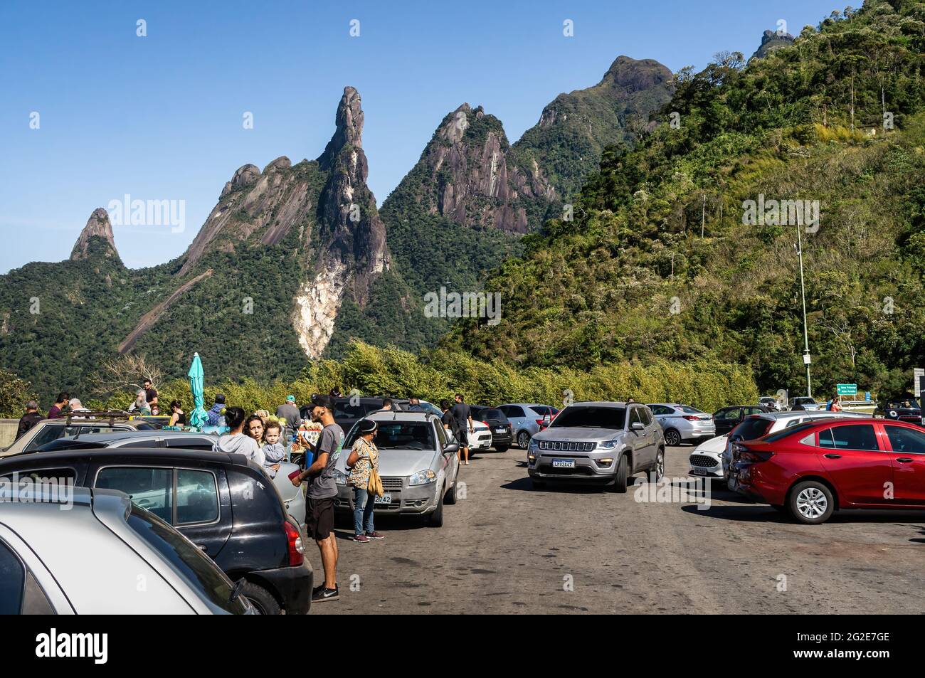 Parking area of Soberbo viewing spot at Rio-Teresopolis highway (BR-116) with Our Lady finger, God's Finger and Cabeca de Peixe peaks at the back. Stock Photo