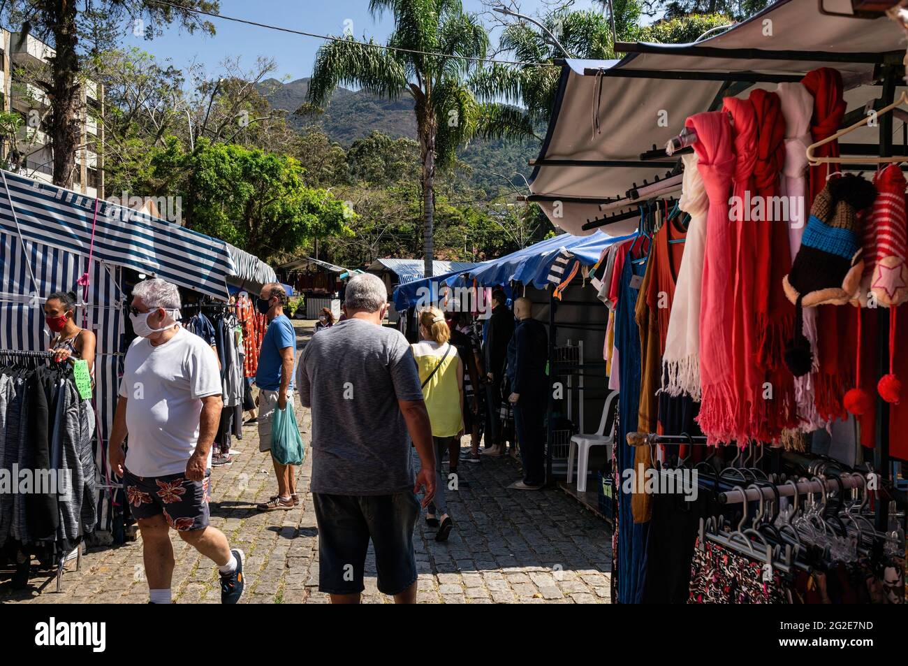 People walking and browsing items for sale in Alto Fair, a public market located in the surroundings of Higino da Silveira square, Alto district. Stock Photo