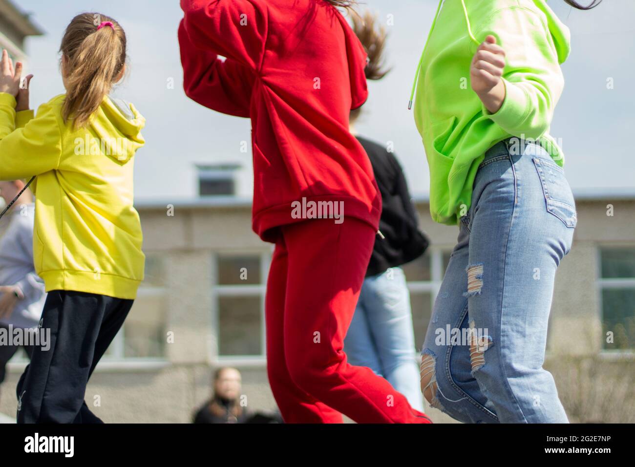 Children are dancing in the street. Many children dance to the music in the city. Schoolchildren perform at a dance lesson. Stock Photo