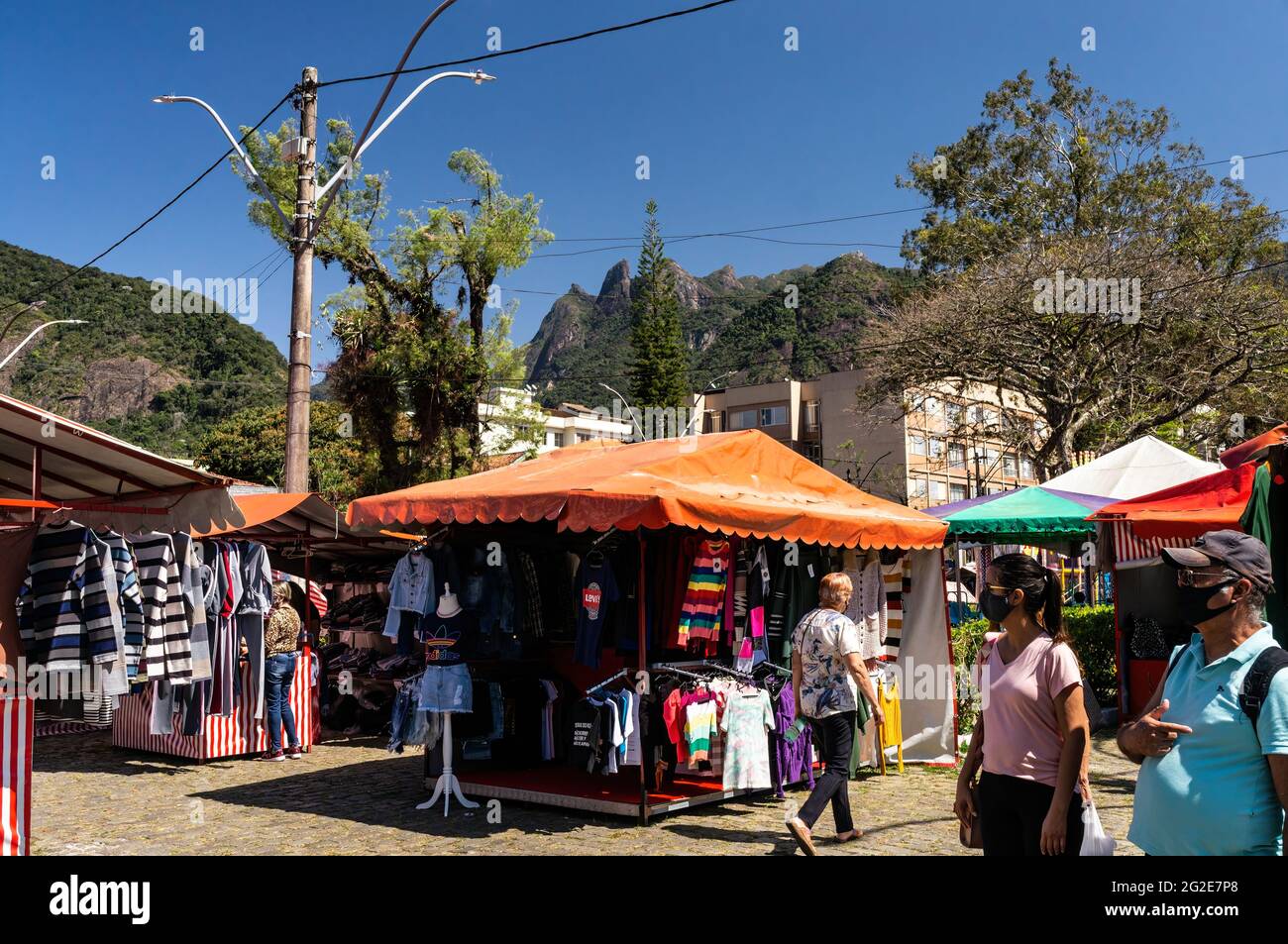 People walking and browsing items for sale in Alto Fair, a public market located in the surroundings of Higino da Silveira square, Alto district. Stock Photo