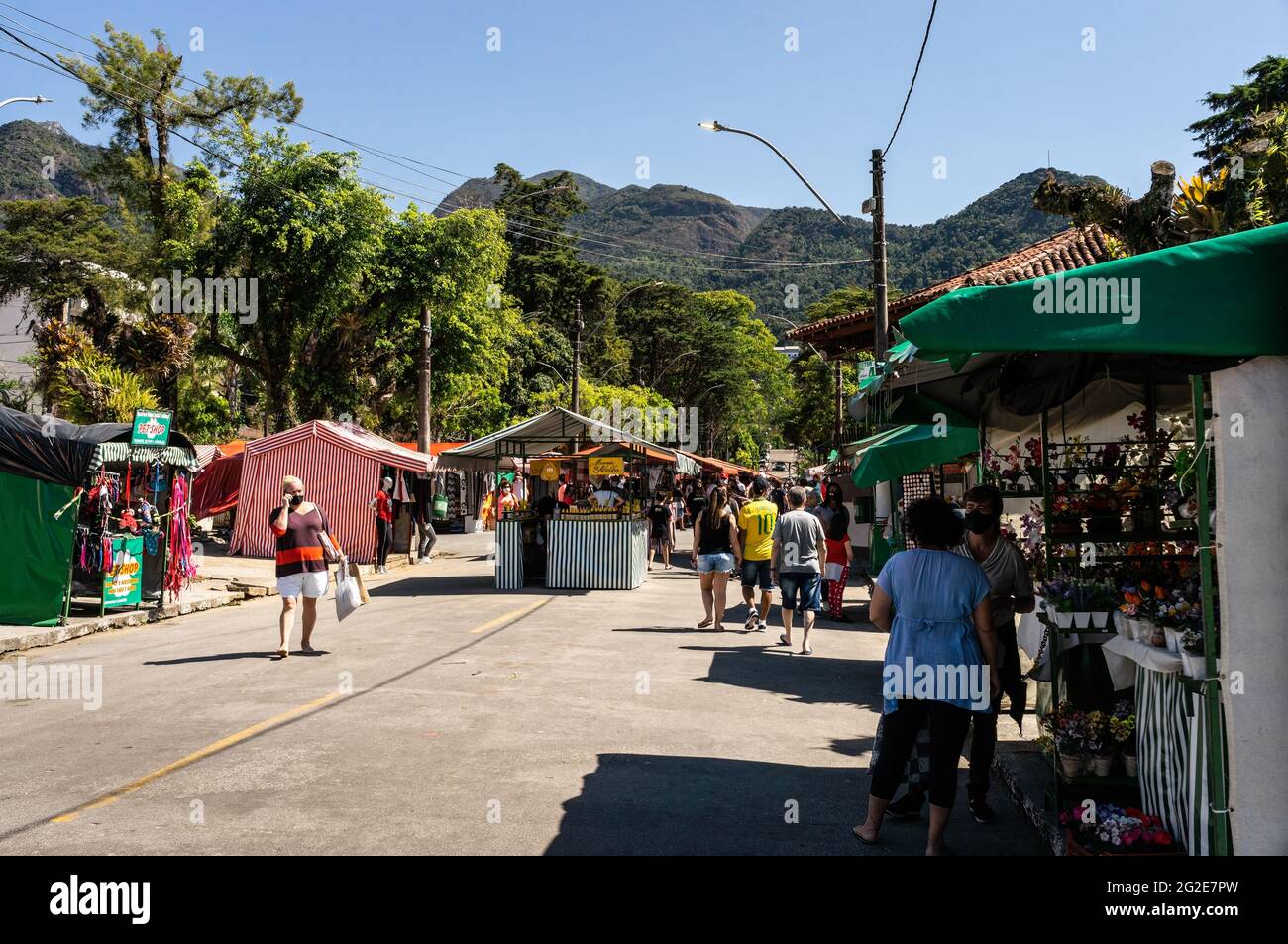 People walking and browsing items for sale in Alto Fair, a public market located in the surroundings of Higino da Silveira square, Alto district. Stock Photo