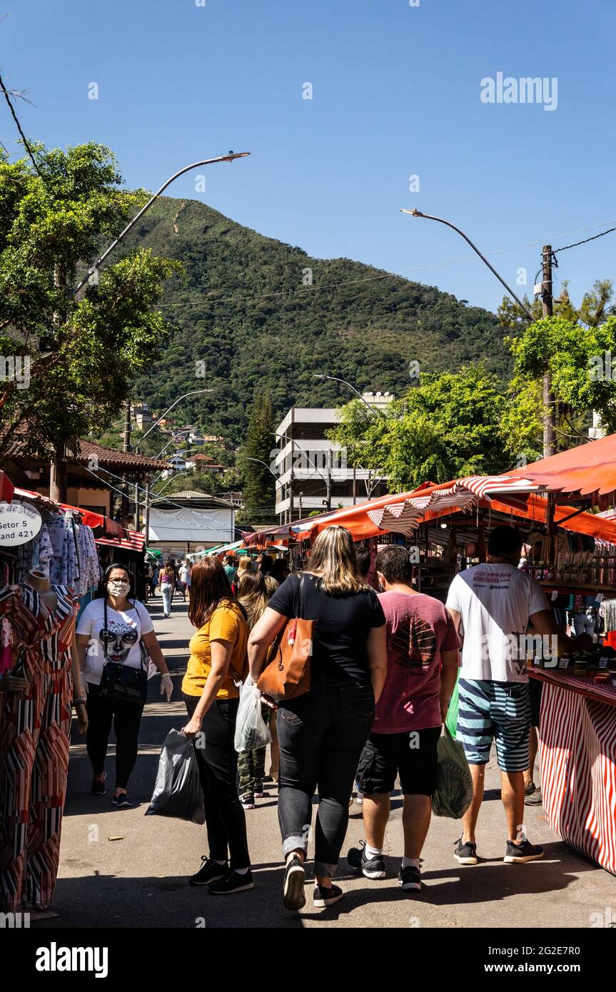 Costumers walking and browsing items in Alto Fair tents, a public market located in the surroundings of Higino da Silveira square, Alto district. Stock Photo