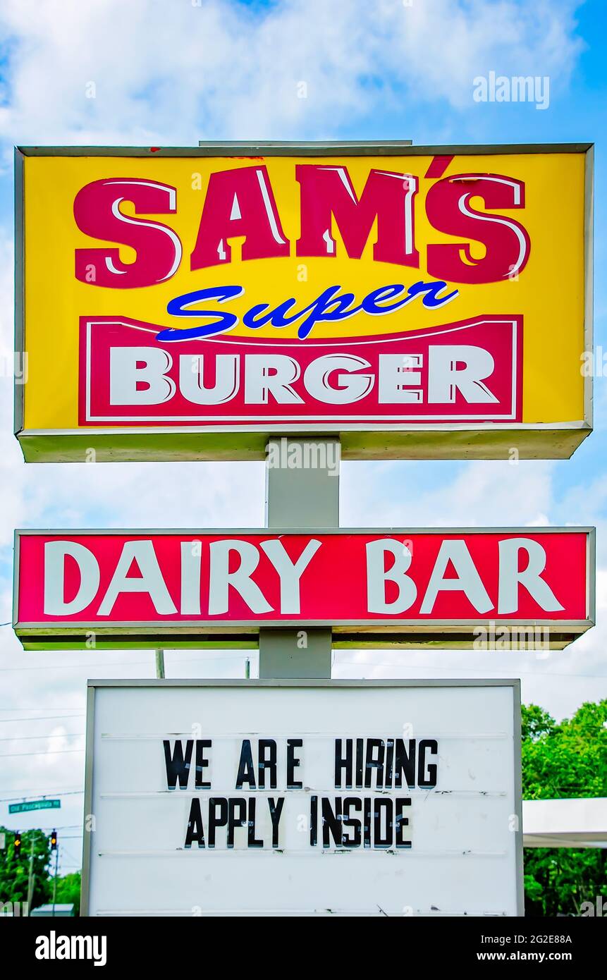 The Sam’s Super Burger sign is pictured with a sign indicating the fast-food restaurant is currently hiring, June 9, 2021, in Grand Bay, Alabama. Stock Photo