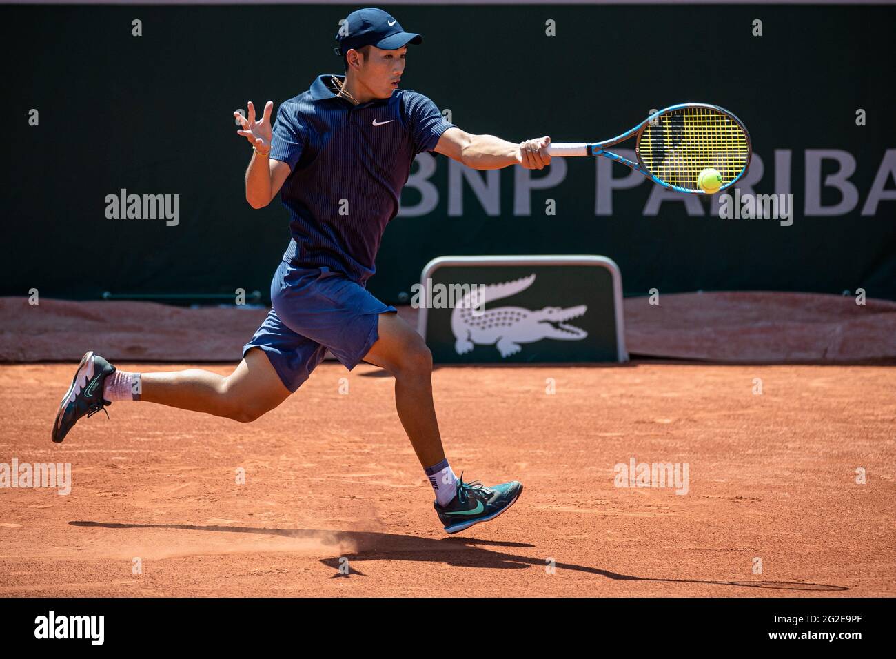 Paris, France. 10th June, 2021. Shang Juncheng of China returns the ball during the boys' singles quarterfinal match between Shang Juncheng of China and Sean Cuenin of France at the French Open tennis tournament at Roland Garros in Paris, France, June 10, 2021. Credit: Aurelien Morissard/Xinhua/Alamy Live News Stock Photo