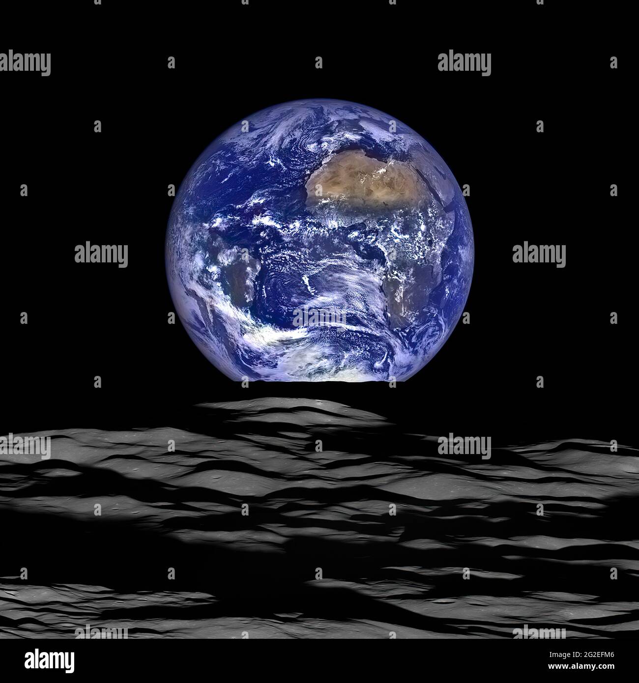 The Earth rises above the lunar horizon in this photograph taken from the moon. Stock Photo
