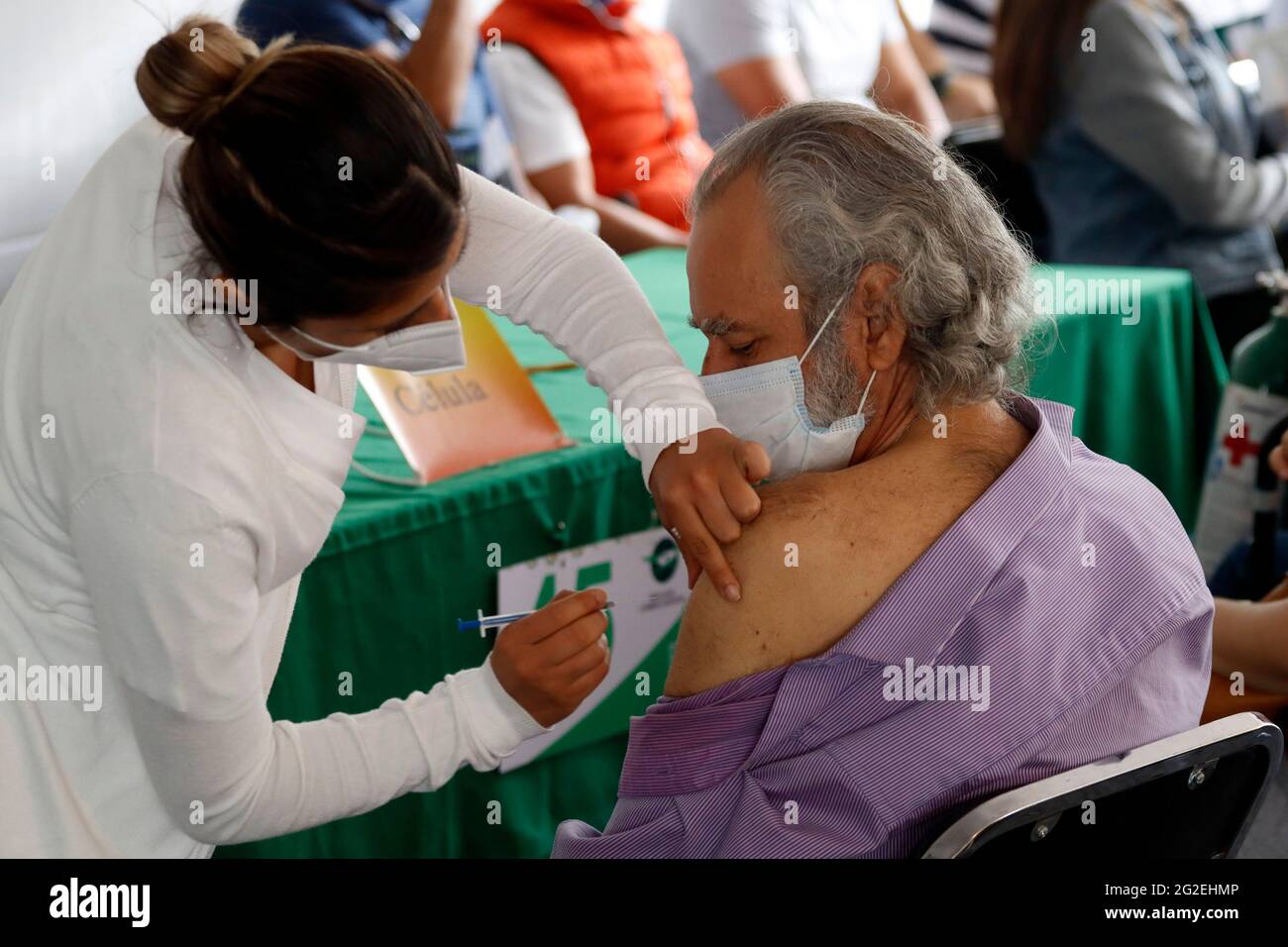 Non Exclusive: MEXICO CITY, MEXICO - JUNE 10: A person receives  a Pfizer BioNTech dose during mass vaccination campaign for people of 40 to 49 years Stock Photo