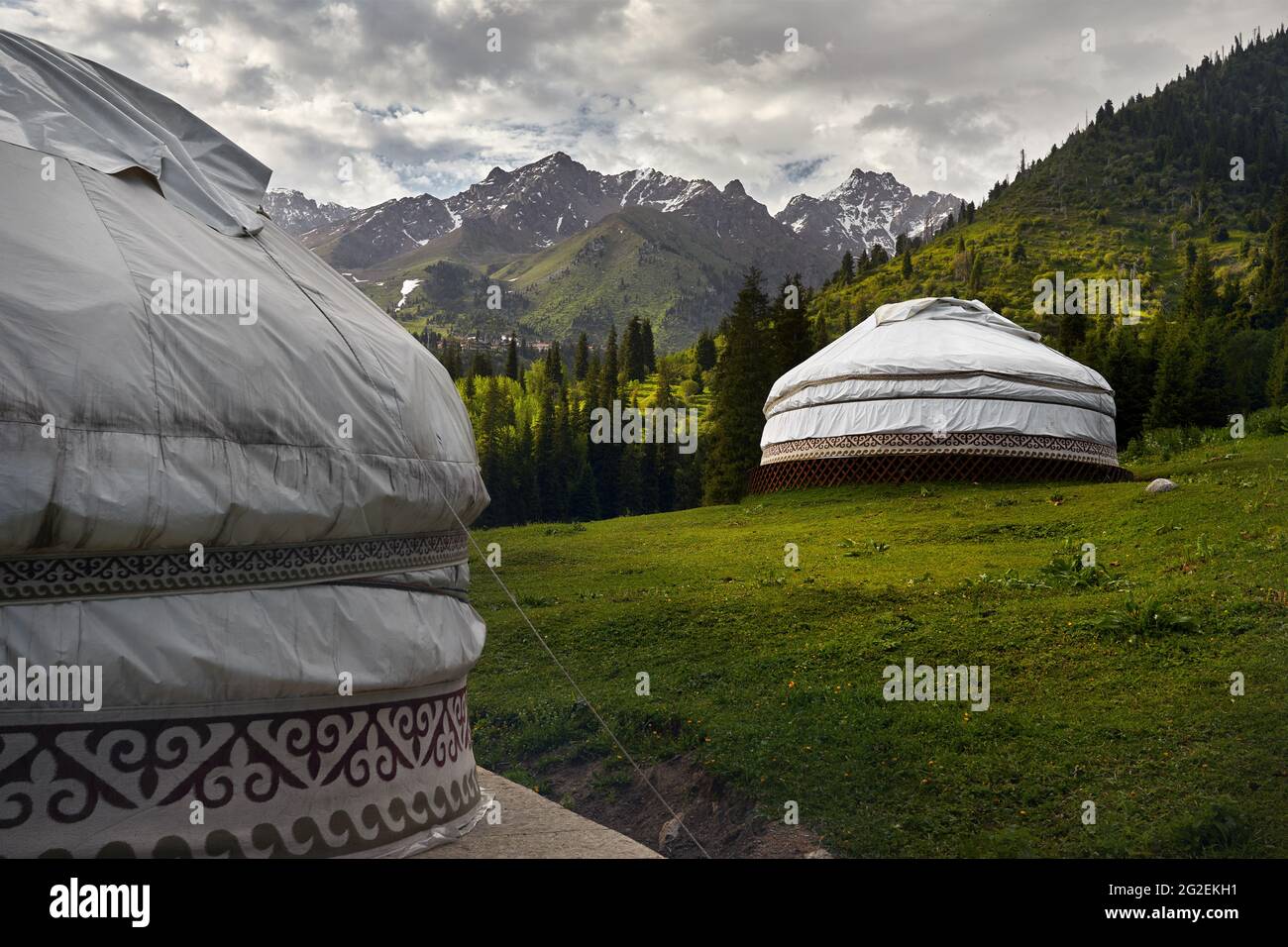 Guest house complex of white Yurt nomadic house at green mountain valley in Almaty, Kazakhstan Stock Photo