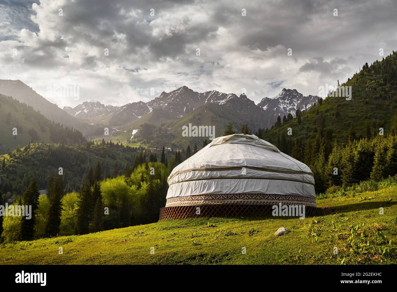 Guest house complex of white Yurt nomadic house at green mountain valley in Almaty, Kazakhstan Stock Photo