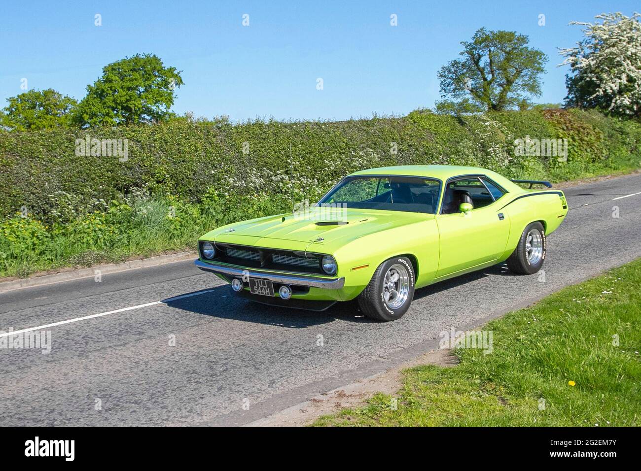 1970s 70s green American Plymouth 383 6200cc petrol 2dr coupe, en route to Capesthorne Hall classic May car show, Cheshire, UK Stock Photo
