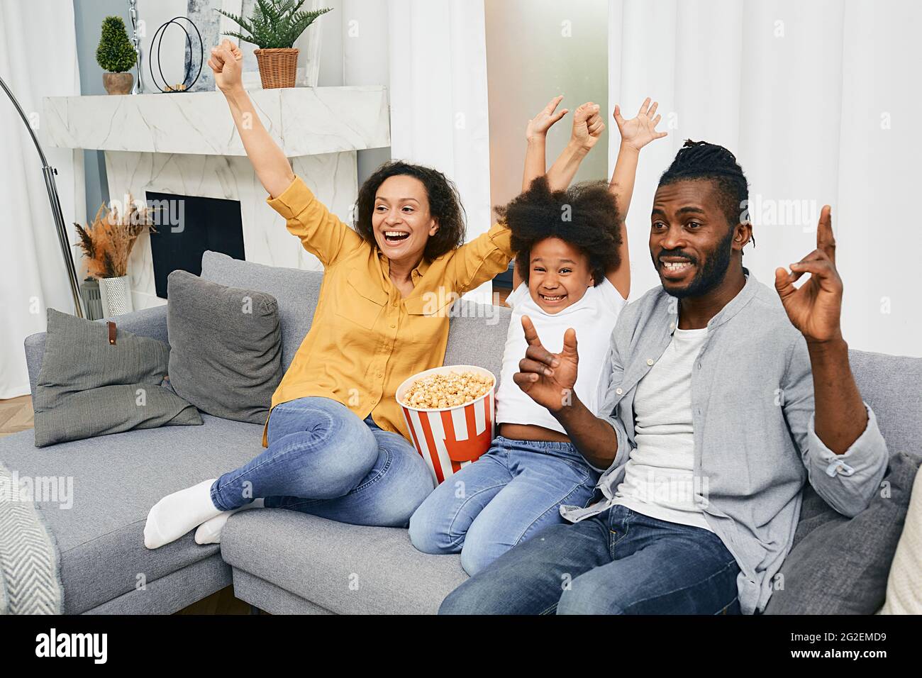 Home cinema theater. Family emotionally watching together fun tv show Stock Photo