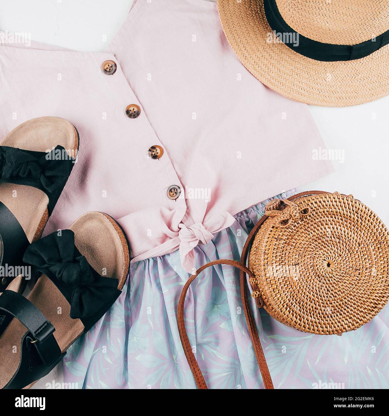 Summer holiday clothes. Female fashion outfit - skirt, top, hat, bag, sandals. Top view, flat lay Stock Photo