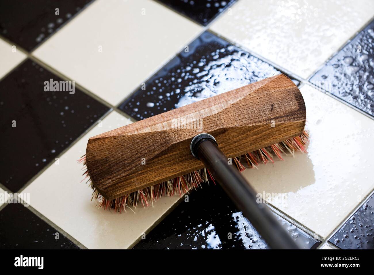 Scrubbing a tiled floor Stock Photo