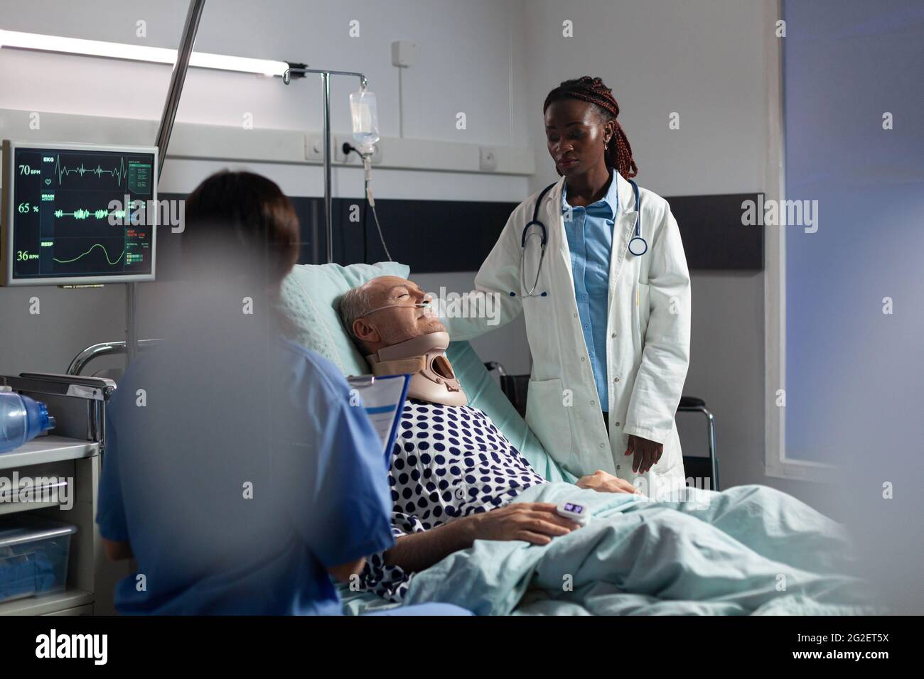 Injured senior man with neck brace laying in bed suffering after