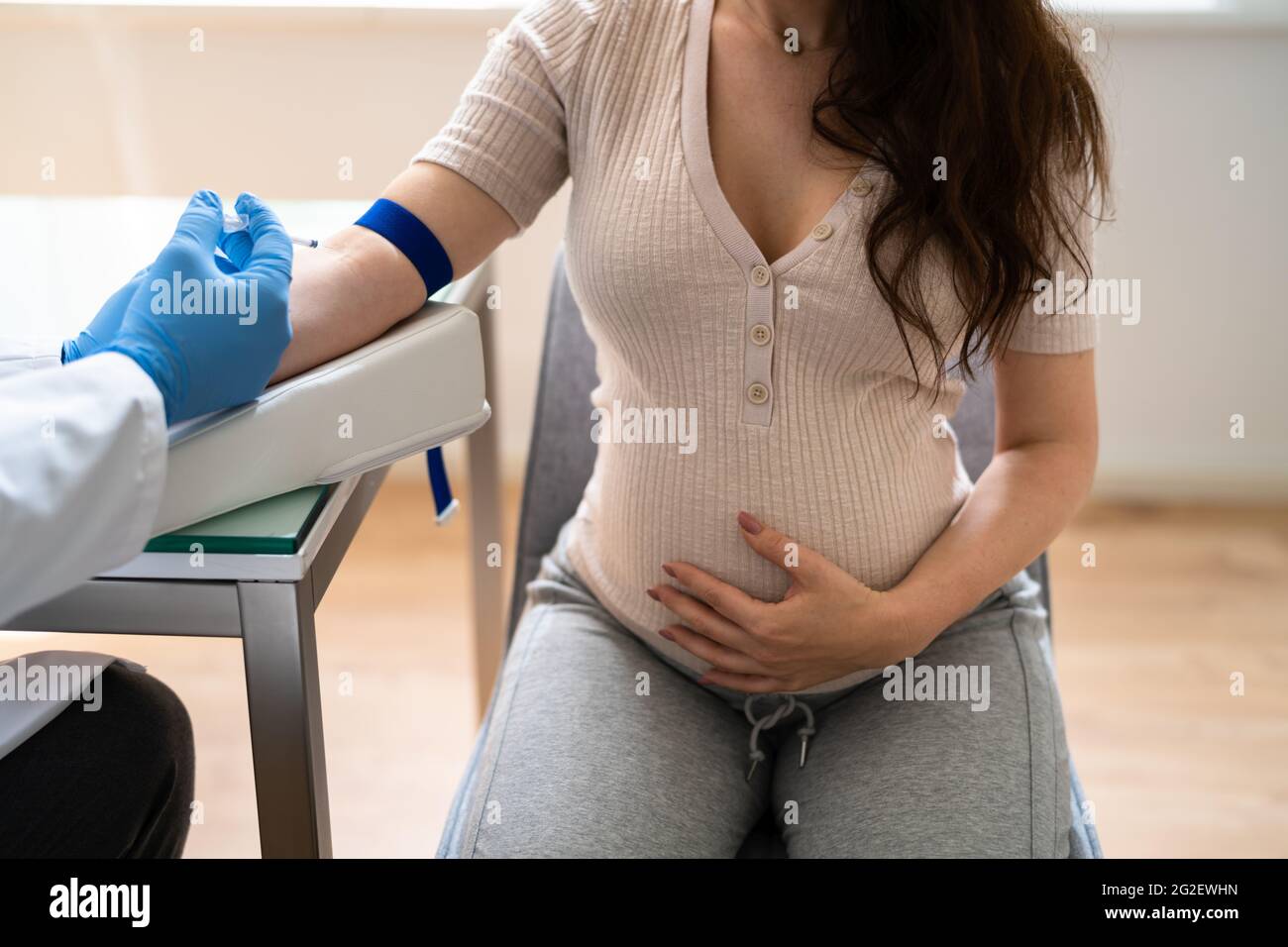 Prenatal Screening. Doctor Drawing Blood Sample From Pregnant Woman Stock Photo