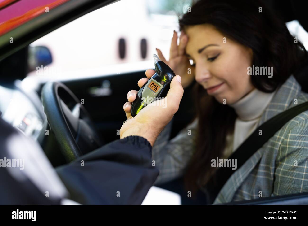 Sad Woman With Alcohol Intoxication Stopped By Policeman Stock Photo