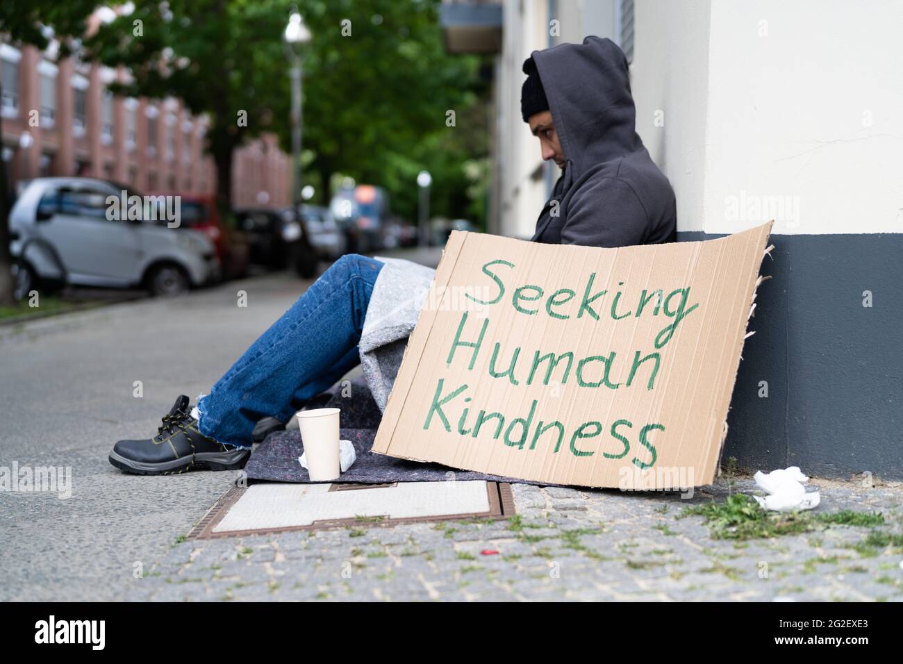 Homeless Lonely Poor Man With Cardboard Seeking Kindness Stock Photo