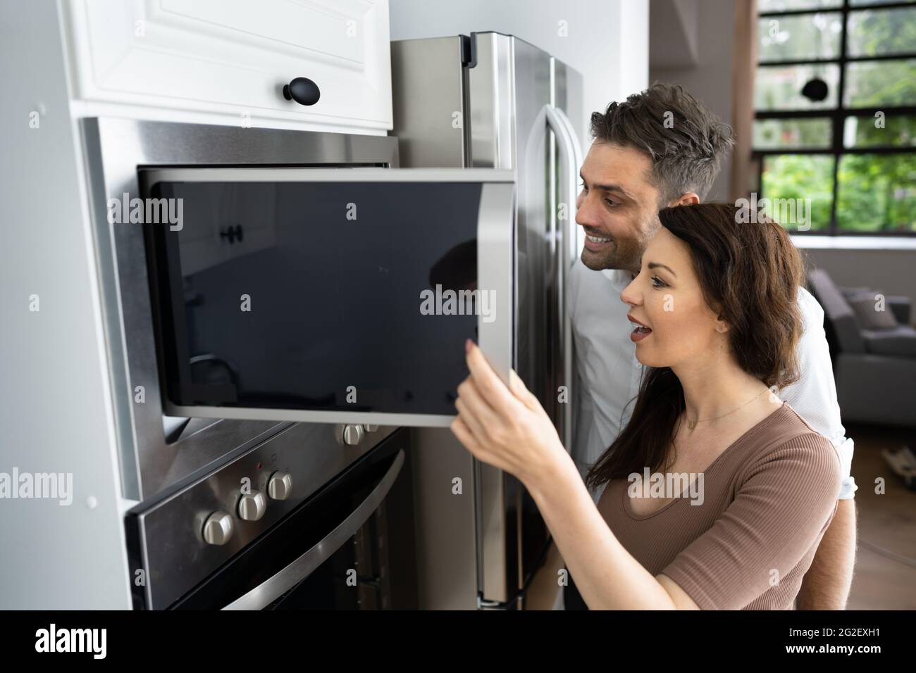 Couple Microwave Electrical Oven With Consumer Loan Credit Stock Photo