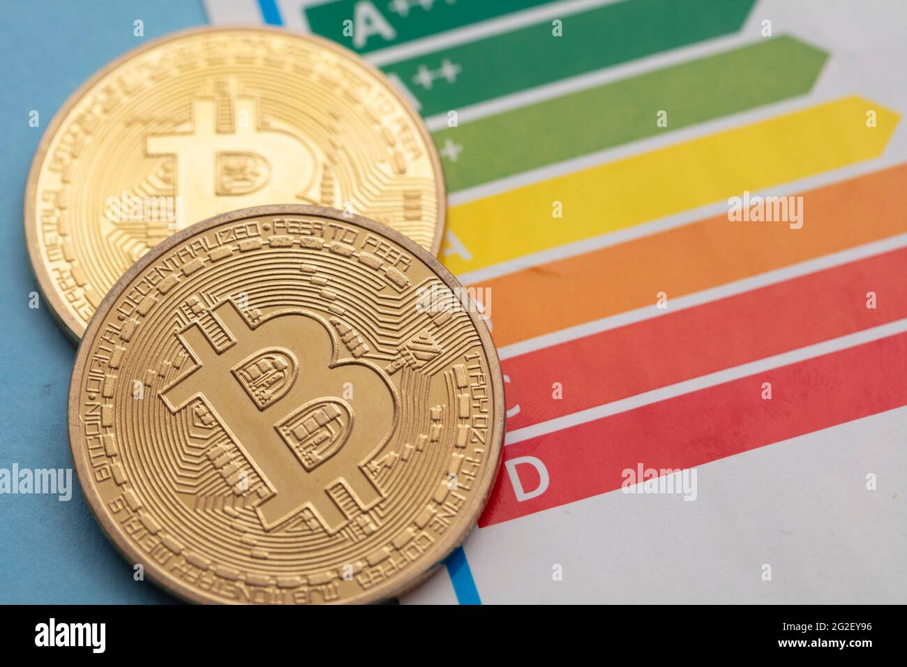 Bitcoin cryptocurrency gold coin with an energy efficiency rating chart Stock Photo