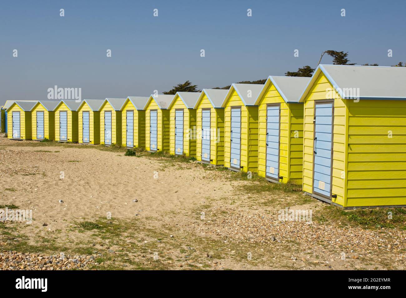 Colourful yellow and blue beach huts on the seafront at Littlehampton, West Sussex, England