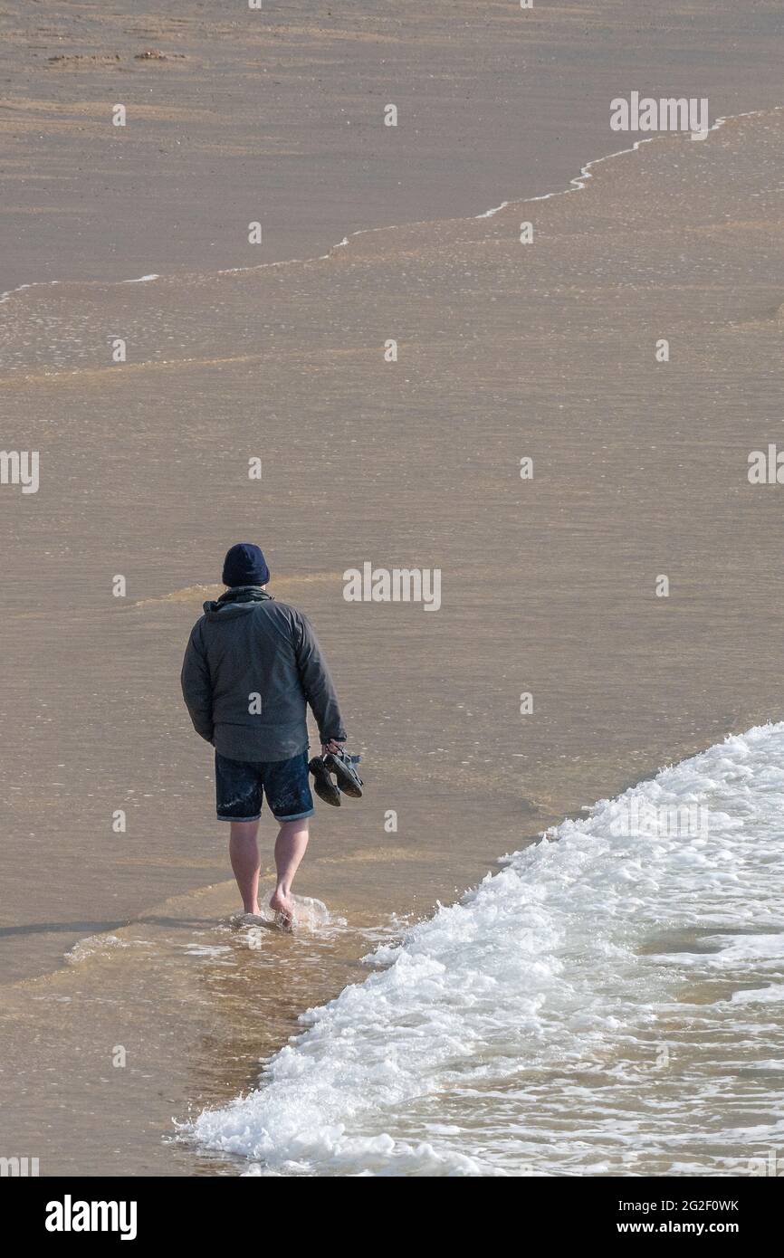 Man walking barefoot on beach hi-res stock photography and images - Alamy