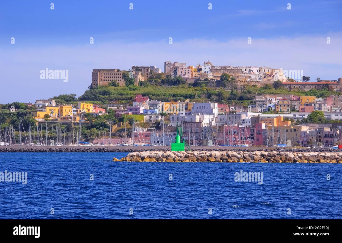 Panoramic view of Procida, Italian Capital of Culture 2022: colorful houses, cafes and restaurants, fishing boats in Marina Grande.in Bay of Naples. Stock Photo