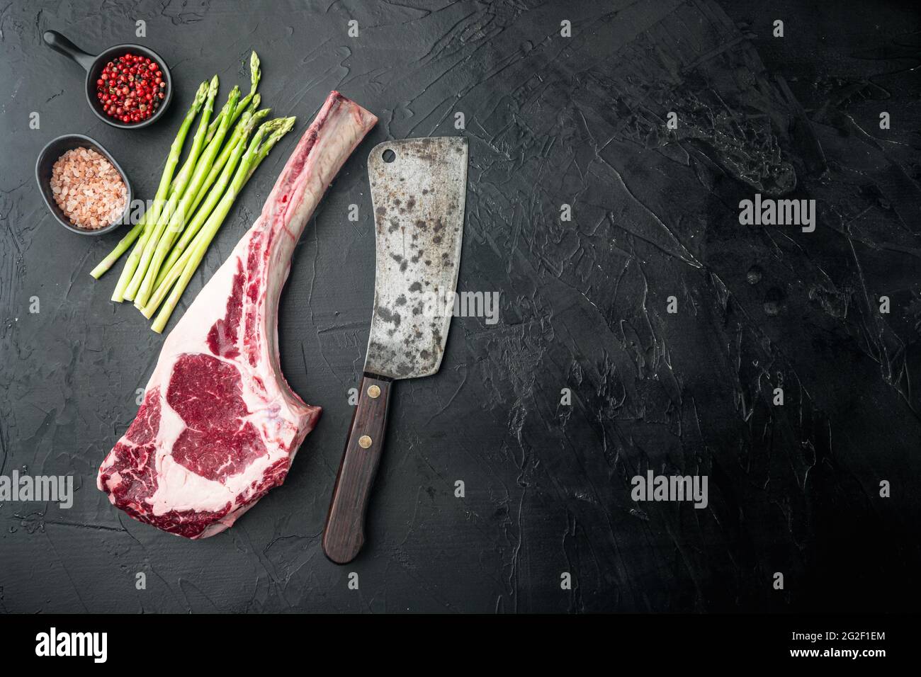 Classic Fresh Beef Striploin Steaks Set Tomahawk Cut On Black Stone Background Top View Flat