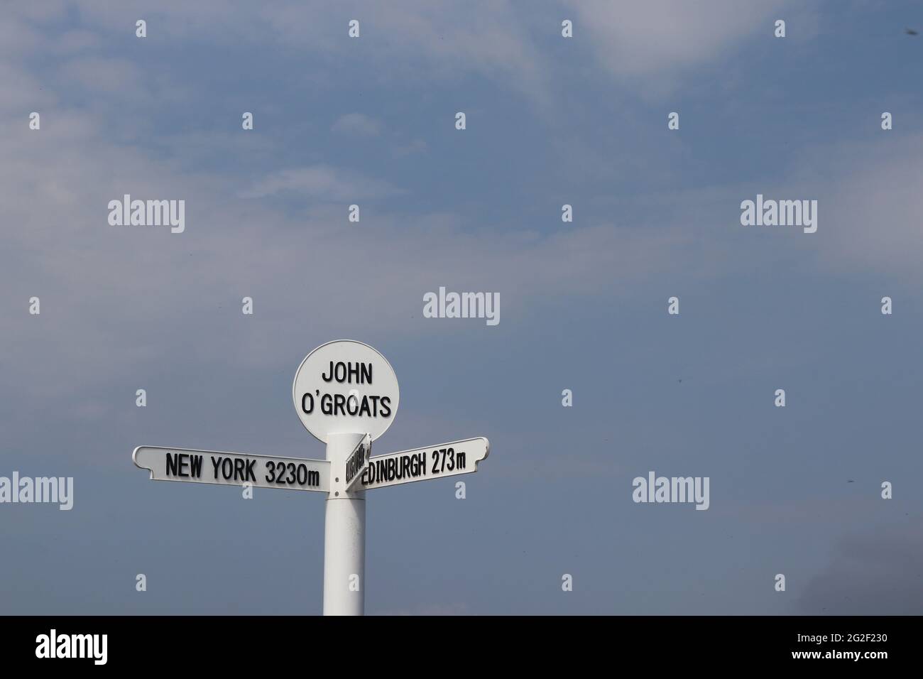 Famous signpost at John O'Groats on the most northerly point on the Scottish mainland, showing distances to New York, Land's End, Edinburgh, Orkney Stock Photo
