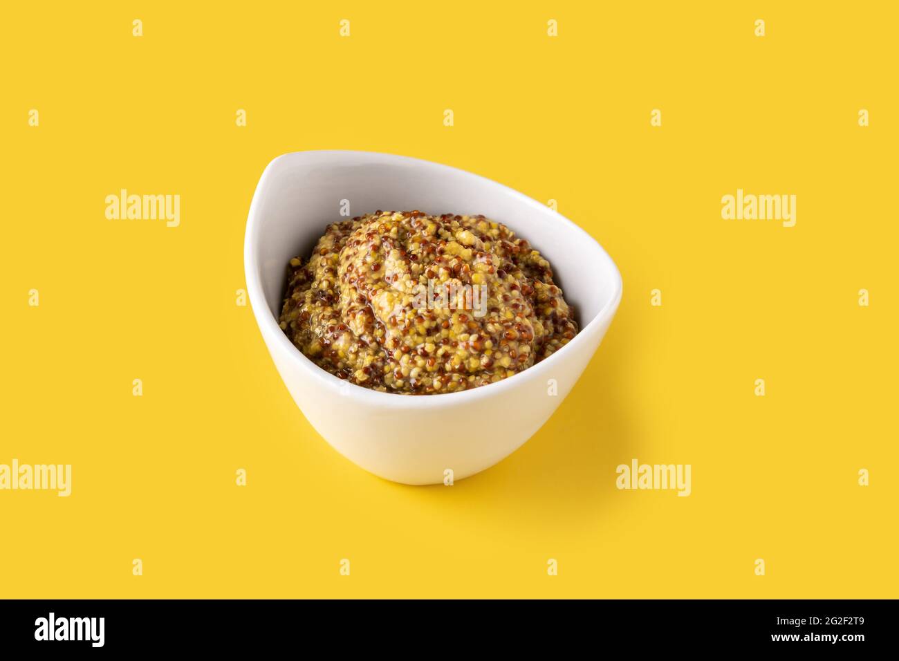Mustard sauce in white bowl and yellow background Stock Photo - Alamy