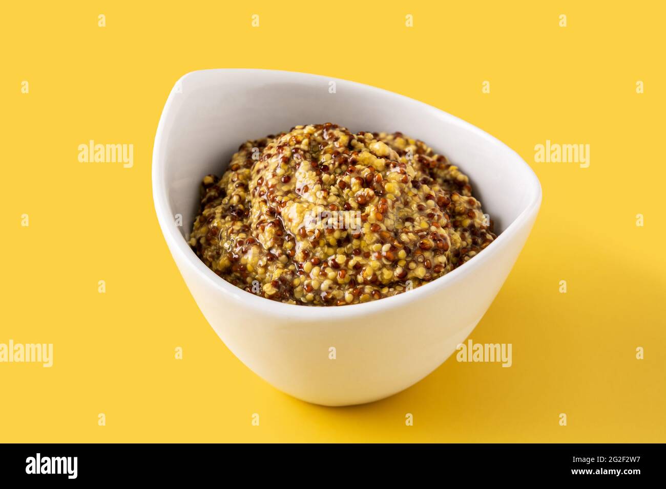 Mustard sauce in white bowl and yellow background Stock Photo - Alamy