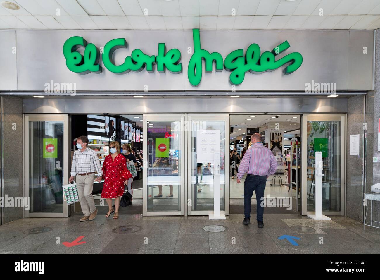 A woman walking by the El Corte Ingles department store under construction  for the upcoming outlet opening Stock Photo - Alamy