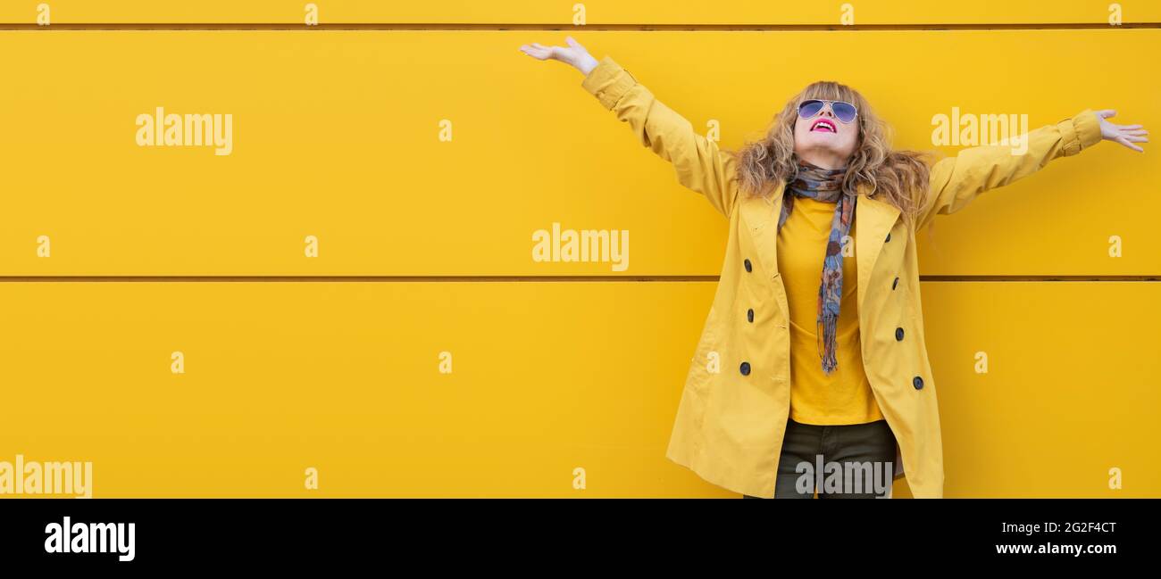 excited woman with raised arms on the street Stock Photo - Alamy