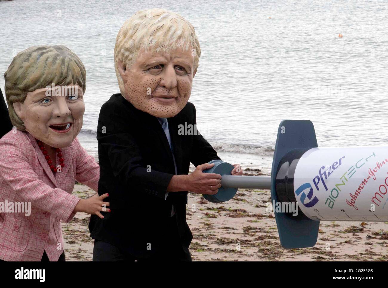 Cornwall, UK. June 11 2021: People dress up on the Swanpool beach, Cornwall, as members of the G7 as part of the People's Vaccine group. 11th June 2021. Anna Hatfield/Pathos Credit: One Up Top Editorial Images/Alamy Live News Stock Photo