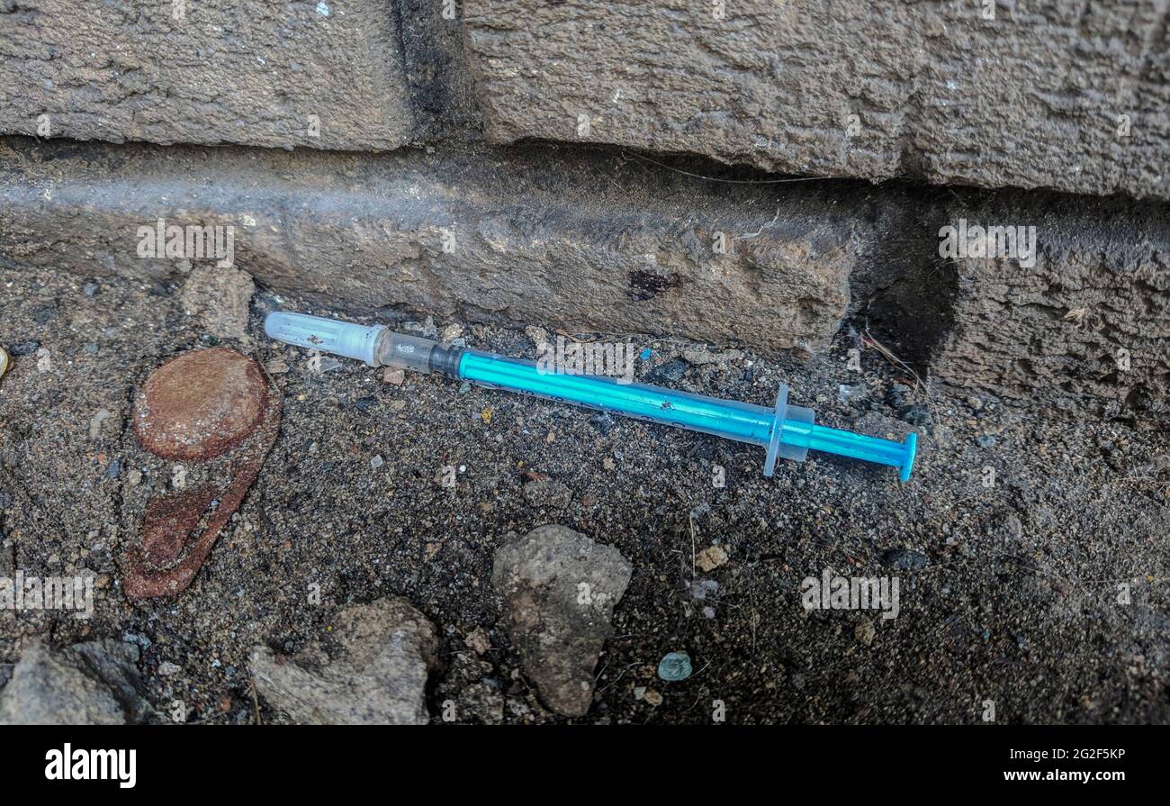 26 May 2019, Swansea, Wales. Two  Used NeverShare Heroin Syringe with Vomit. Real life scenario.Drug overdose and opioid epidemic.  drugs Addiction Stock Photo