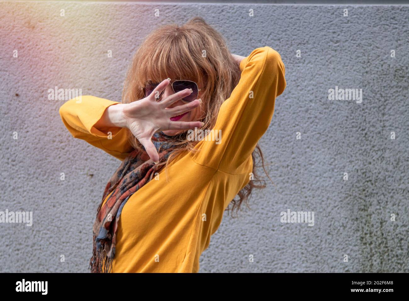 woman covering her face with her hand on the street Stock Photo - Alamy