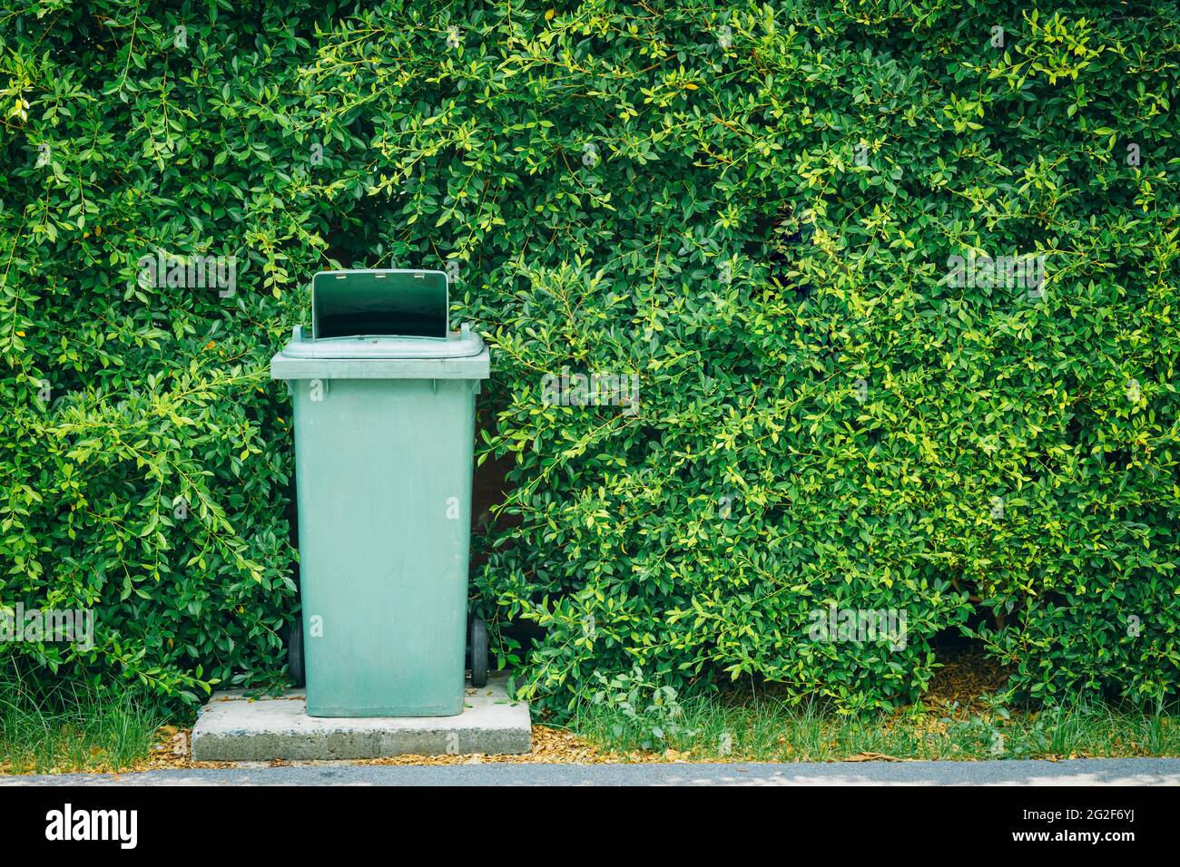 Trash bin garbage waste cabinet place outdoor around green plant with space for text for eco clean city recycle for nature concept Stock Photo