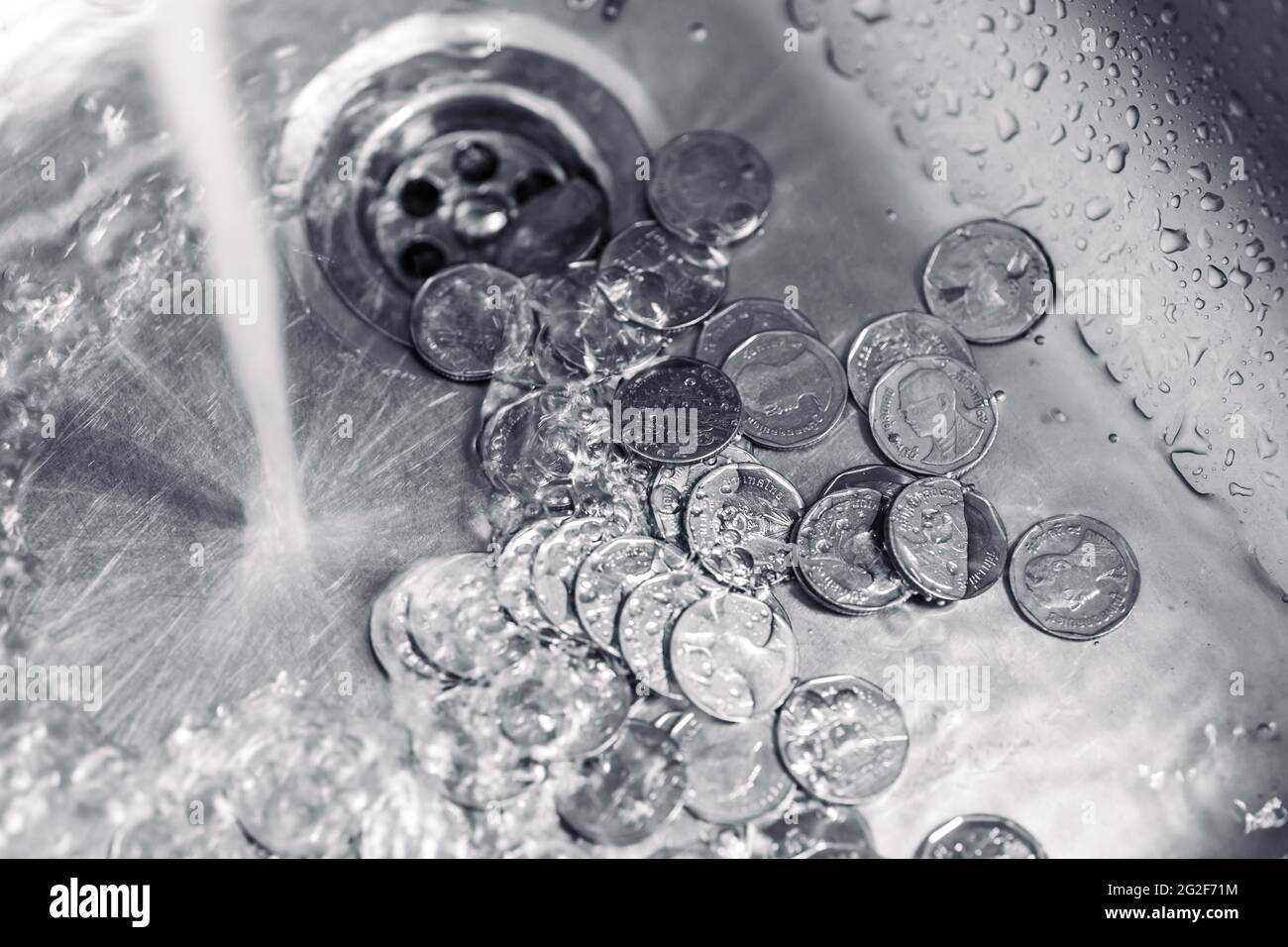 Throwing money down the drain hires stock photography and images Alamy