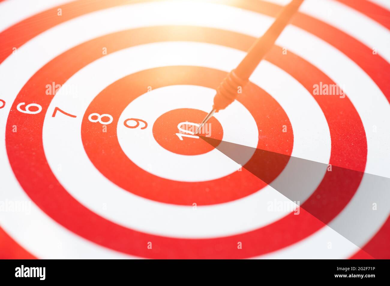 high performance precision red dart arrow hit the center target highest score of dartboard. Business management and planing straight to success go win Stock Photo